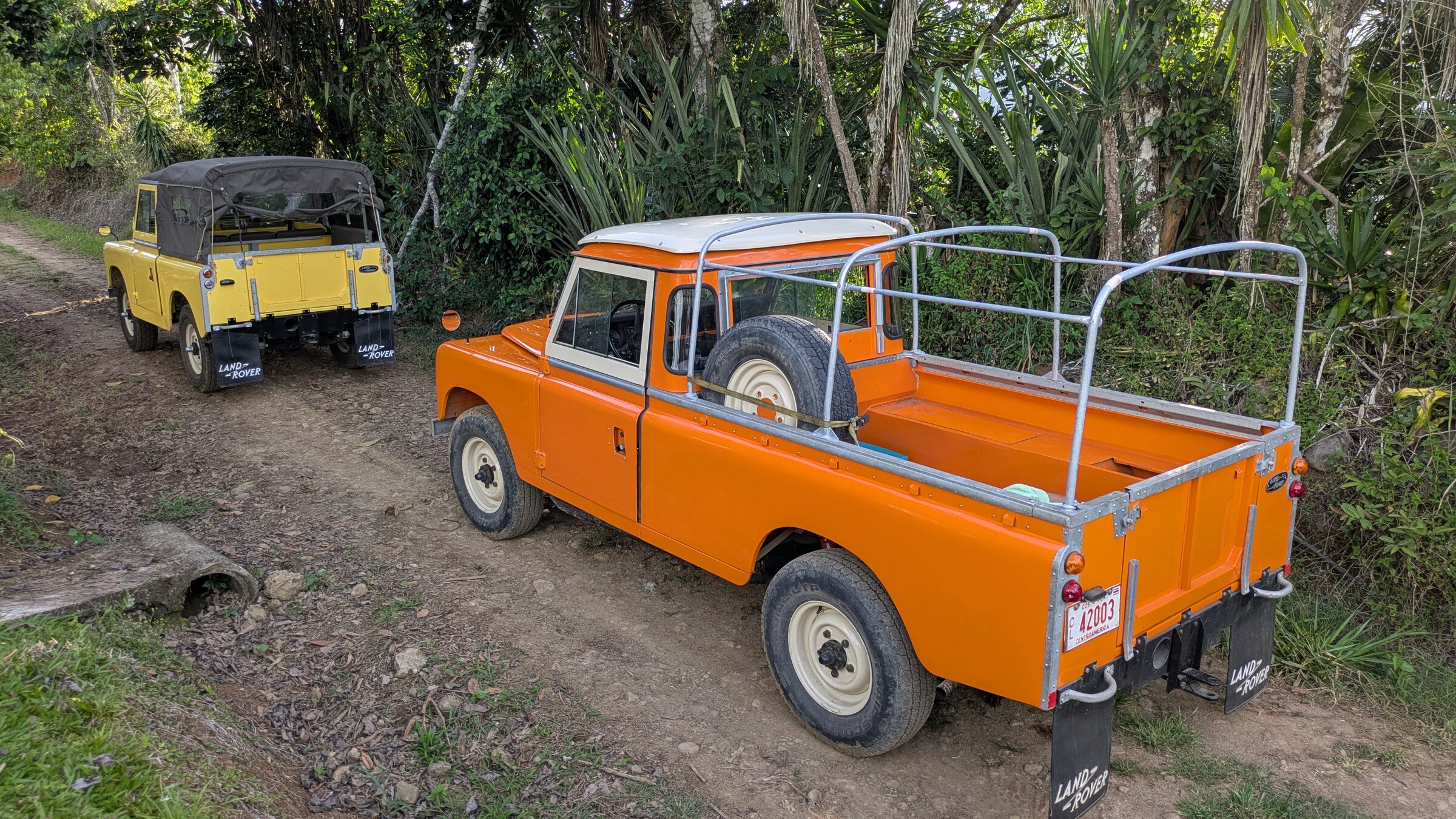 Classic Land Rovers prepared for a guided countryside tour in rural Turrialba