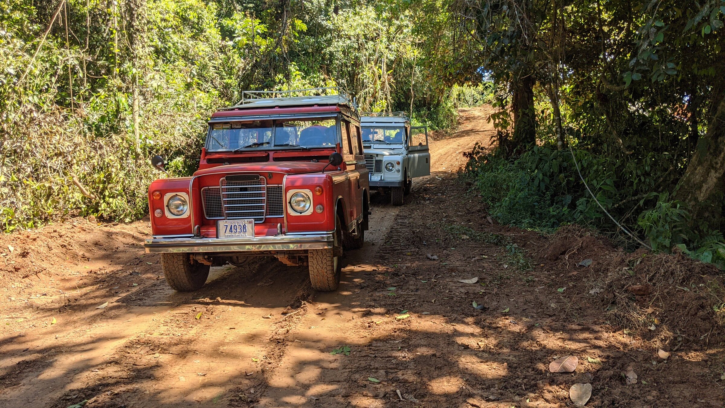 Classic Series Land Rovers traveling together on a rural road in the Turrialba mountains
